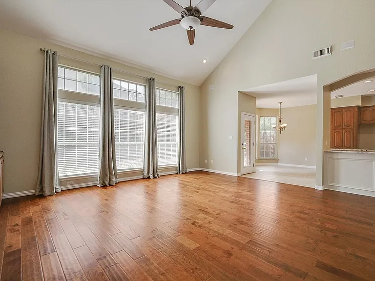 Soaring ceilings, wood flooring, built-ins, fireplace and an abundance of light define this expansive living space
