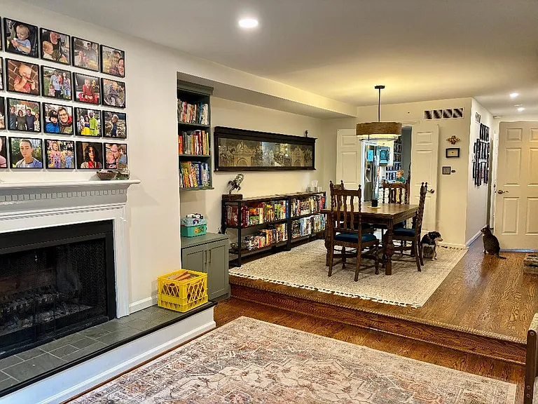 Wide open den and dining rooms. Bookshelves installed this month give you plenty of room for your books, media, or game collections.