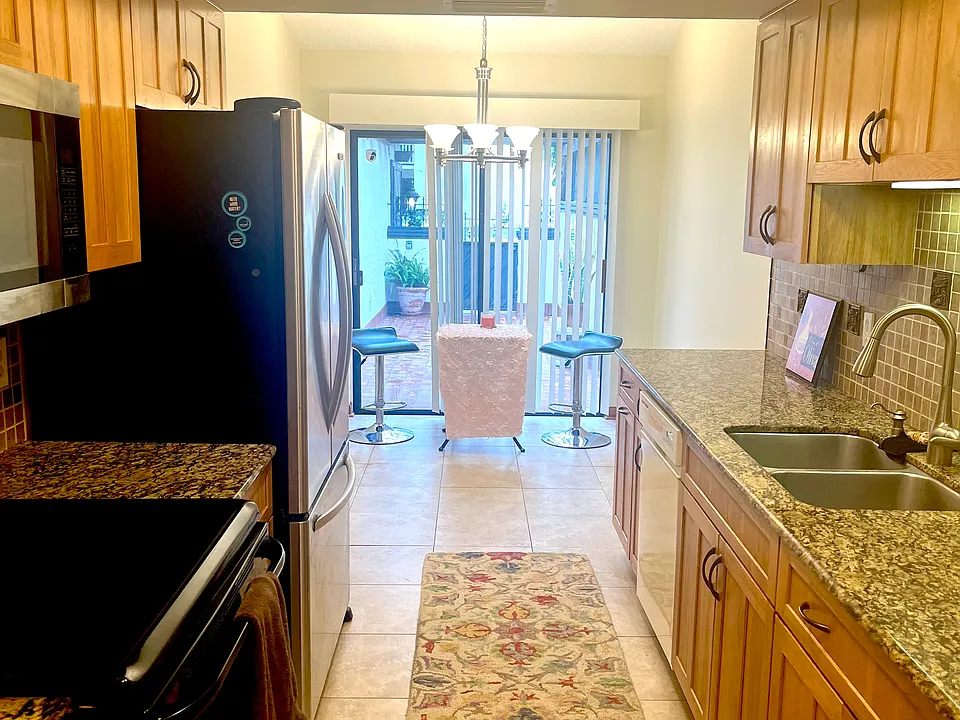Kitchen with breakfast nook and view of front patio.