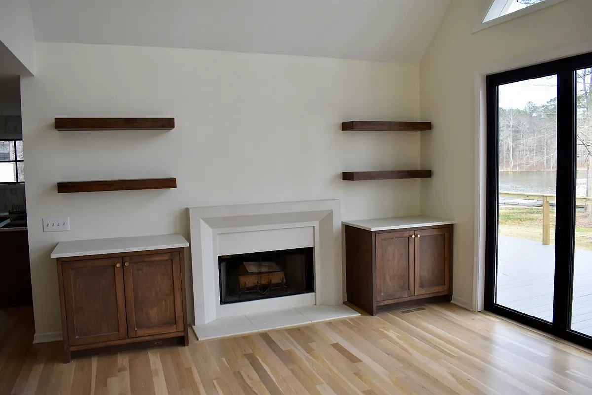 White oak floors, floating shelves, and inset cabinets around the fireplace - 1821 Sugar Creek Trl