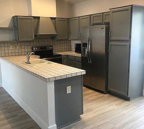 Kitchen, New Stainless Refrigerator, New Stainless Dishwasher and new Range. Door to the garage for easy grocery drop off.