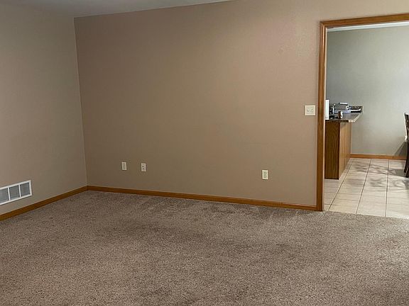 Living room with view into kitchen & eating area