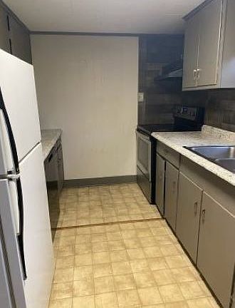 Galley kitchen with frig, stove/oven, dishwasher and microwave