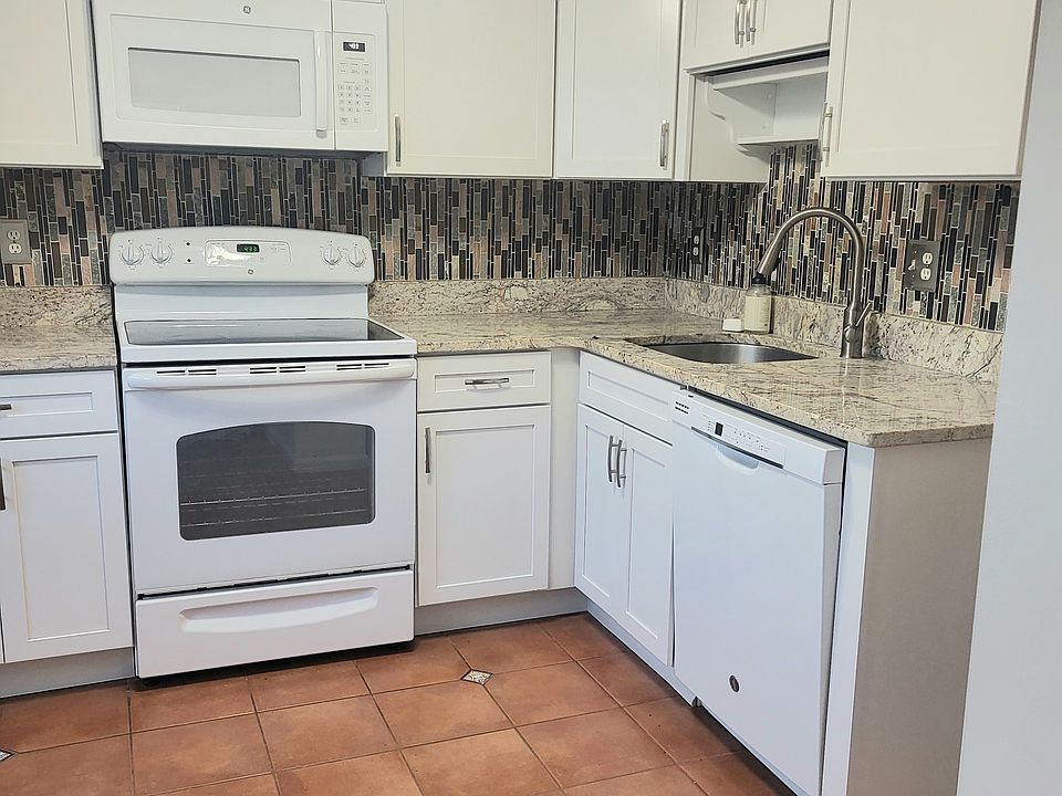 Updated kitchen with granite countertop, electric stove, dishwasher, disposal, ceiling fan