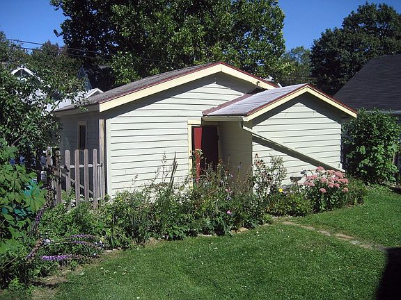 Detached garage is surrounded by newly landscaped native gardens