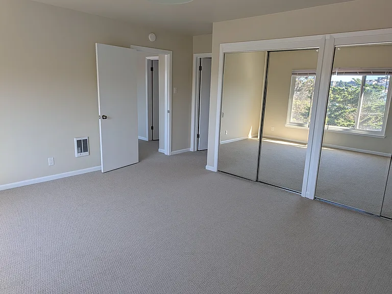 Master bedroom looking to entry and door to bathroom