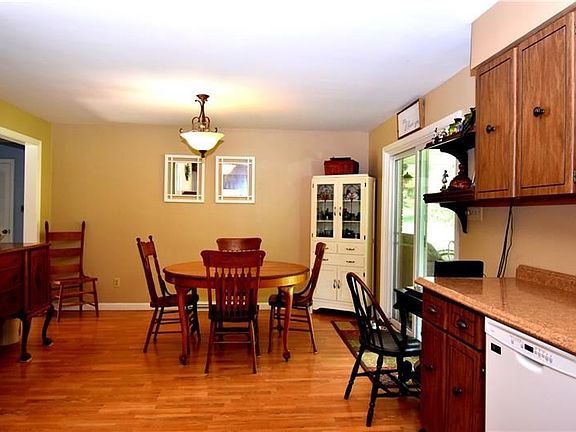 Spacious eat-in kitchen with gleaming hardwood floors