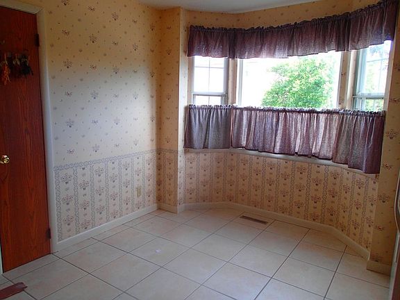 Large, eat in kitchen featuring tile floor and pantry.