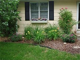 Nicely landscaped with mature bushes and perennials.