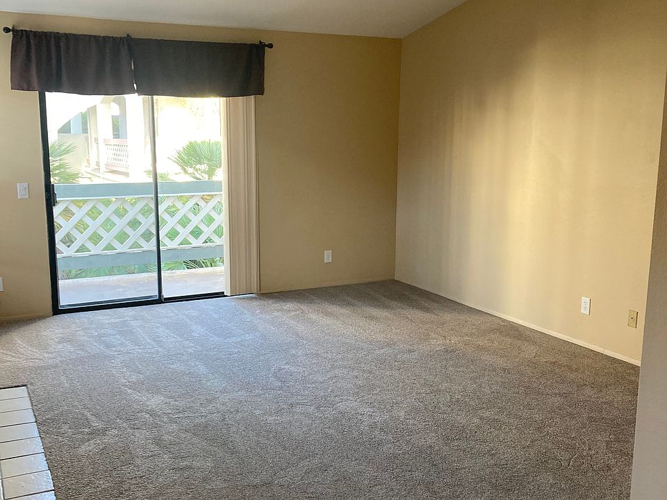 large living room w/ vaulted ceiling & outdoor balcony
