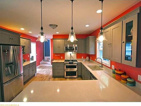 Gourmet kitchen with quartz countertops, custom cabinetry and breakfast bar