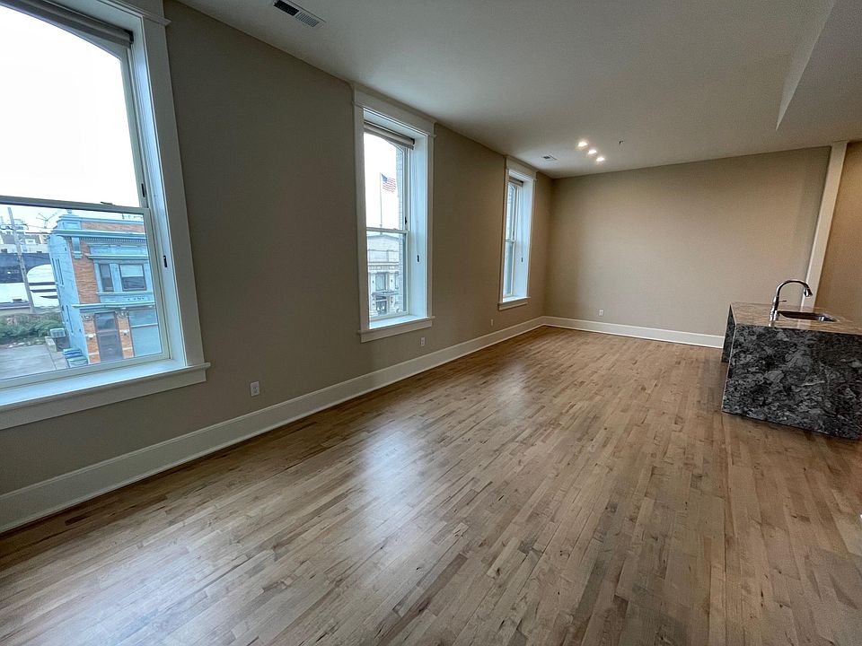 Spacious living area with three north-facing windows.