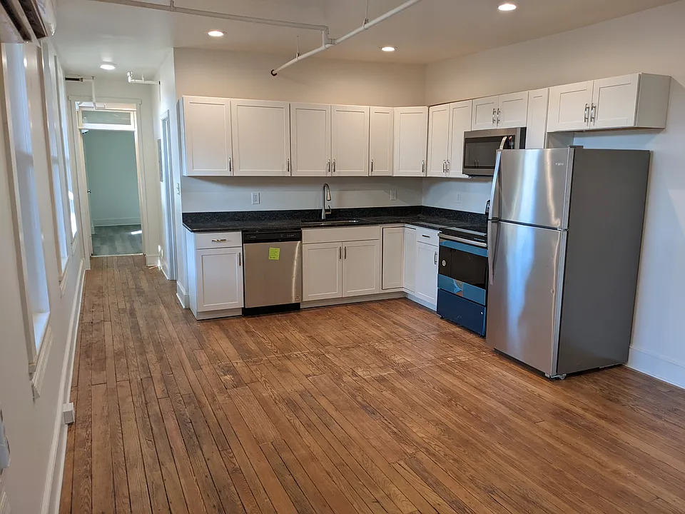 New kitchen with granite counters and stainless steel appliances