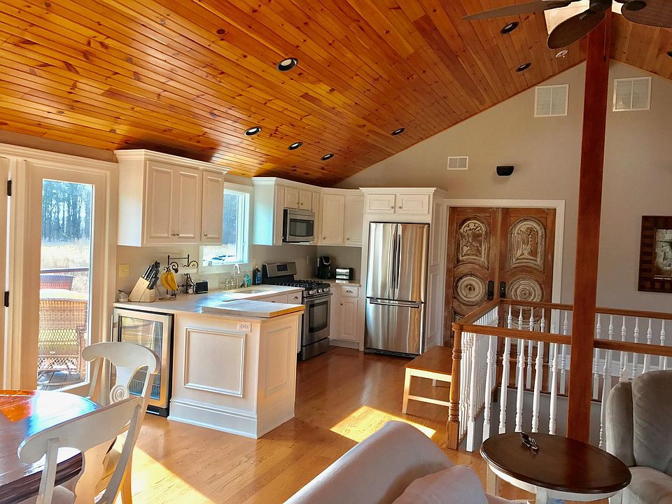 Kitchen with propane stove, microwave, dishwasher, and large fridge.