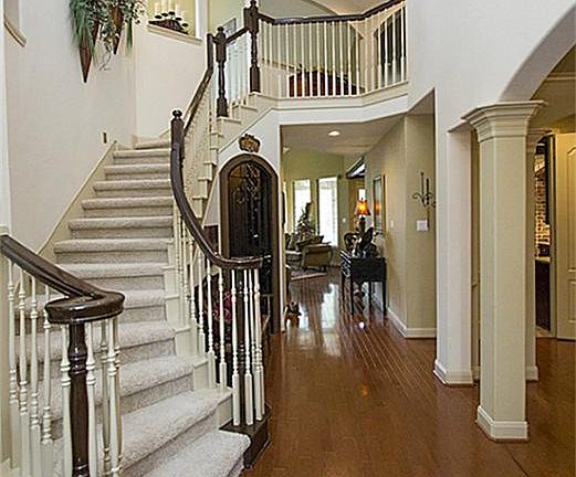Soaring foyer and gleaming hardwood floors sweep you right in. Stairs have night lighting and art niches.