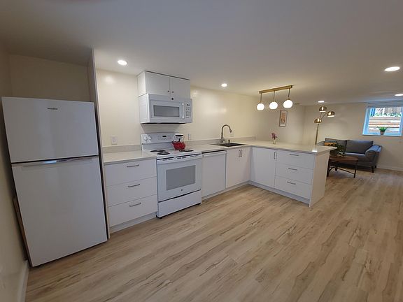 Full size kitchen. Includes fridge, oven/range, microwave, dishwasher, stainless steel sink and breakfast island.