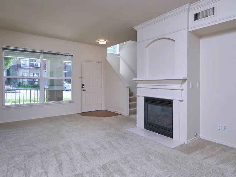 Carpeted Living Room with Fireplace