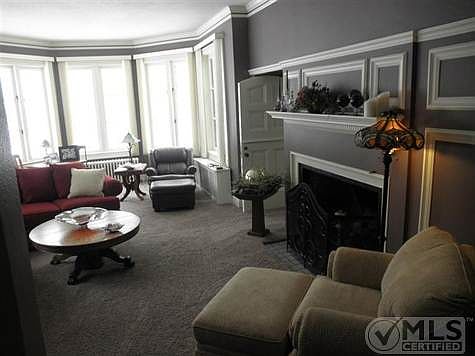Sunken livingroom w/ tall ceilings, long windows ,big bay and large fireplace w/ gas log