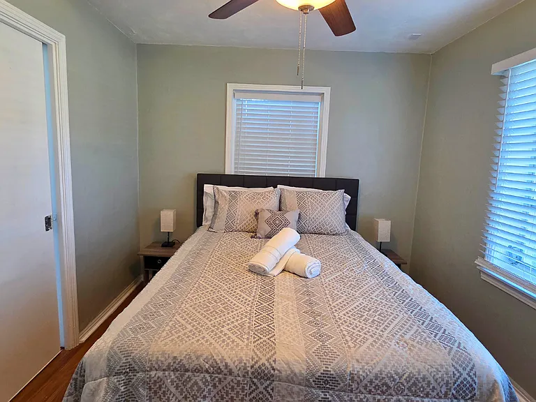 Cozy bedroom with two nightstands, lamps, and spacious closet