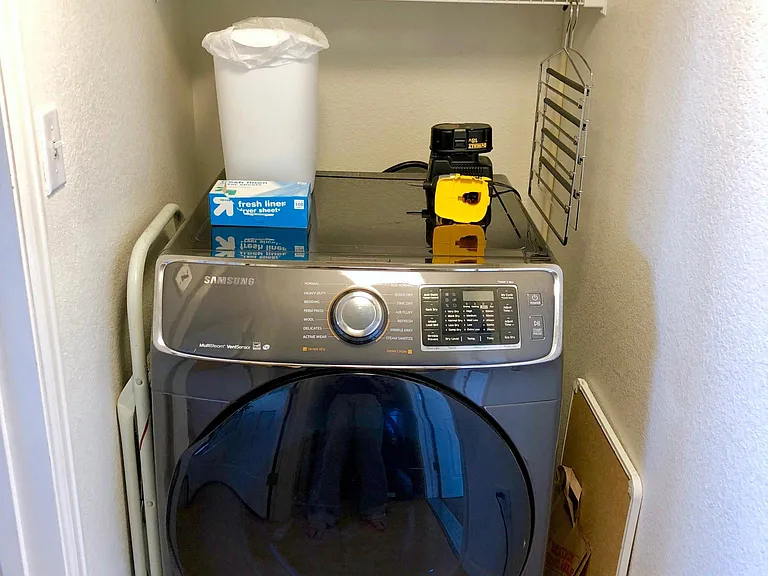 Included dryer with steam setting and storage above