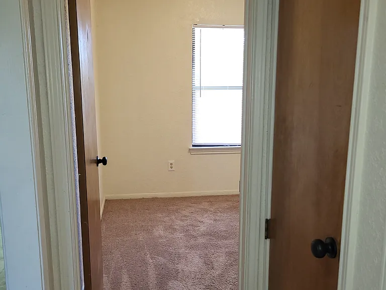 Hallway view of entering third bedroom
