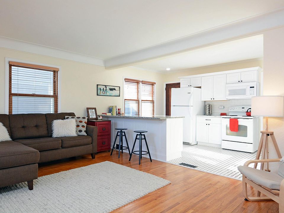 Living room and kitchen with breakfast bar and open layout