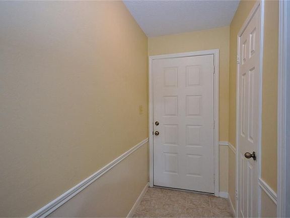 Interior entry with neutral tile, fresh neutral paint and chair rail!