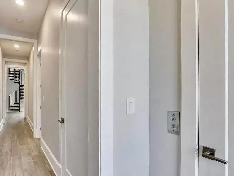 elevator door and hallway towards kitchen and main living area