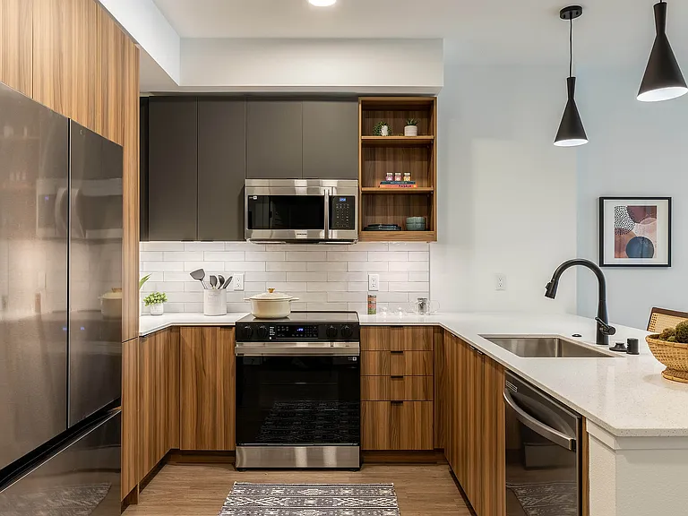 Modern kitchen with warm finish package and quartz countertops