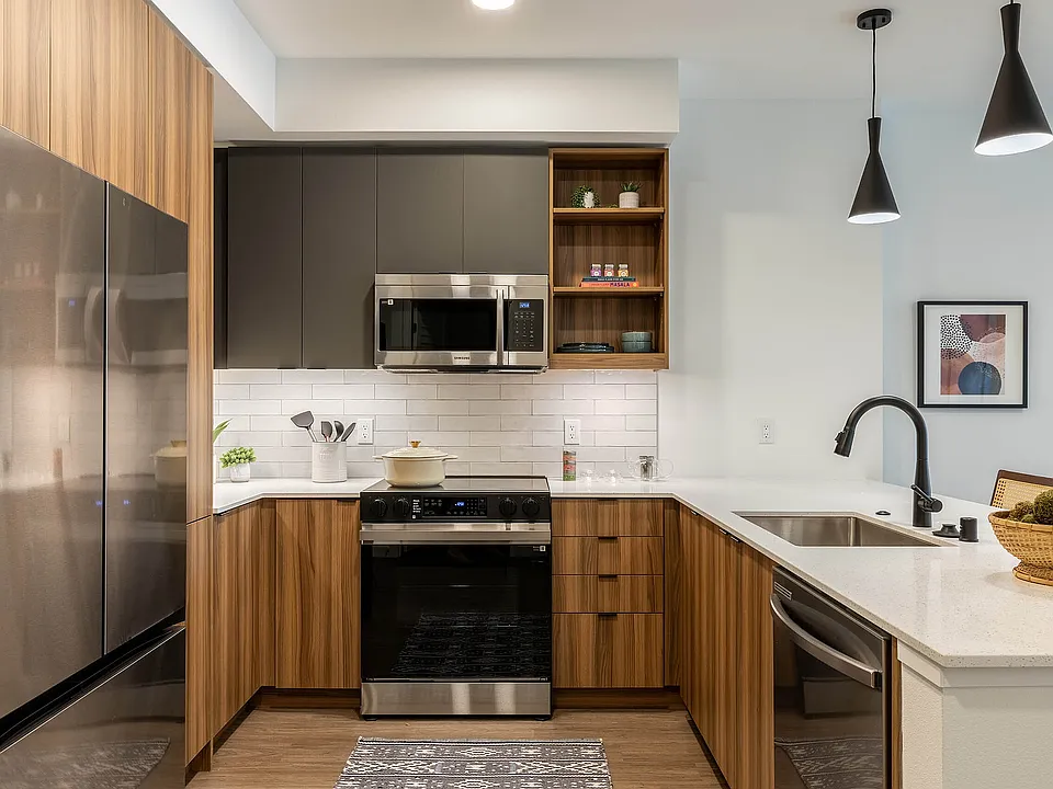 Apartment kitchen and living area with cool finish package