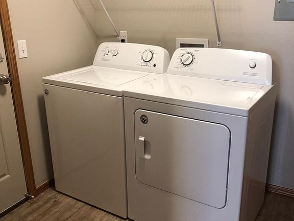 Utility room with washer and dryer included in each unit.