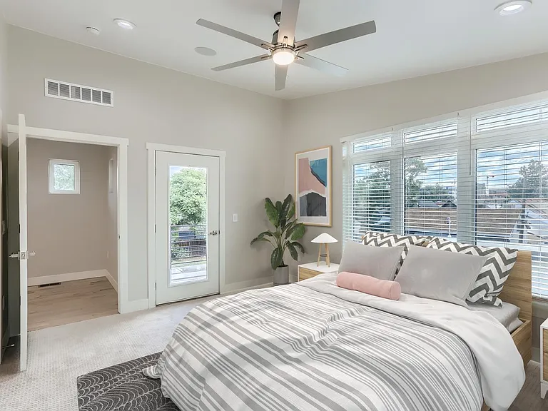 Bedroom 1. This image shows a virtually furnished space. Bedrooms come unfurnished. This room has a walk-in closet, private bathroom and a patio.