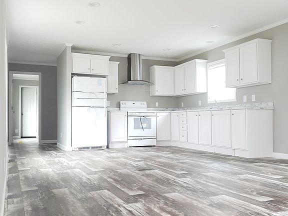 Kitchen with master bedroom with attached bathroom at the end of the hall.
