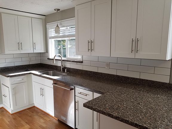 Kitchen. White Shaker cabinets. Quartz counters. Matching stainless Kitchenaid appliances. Tons of storage. Counter extends to allow for two bar stools for eat-in (or wine-in) conversation with the cook/parent/host.