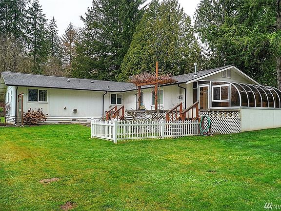 Back yard showing small dog run, back deck and atrium/sunroom