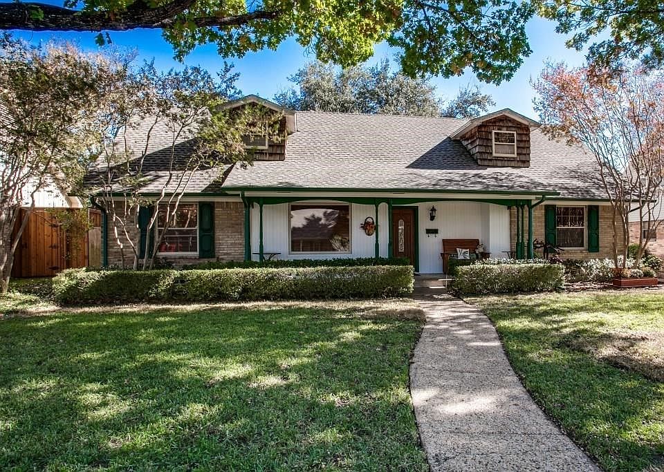 Front of home has two large trees and other nice landscaping