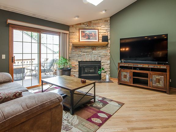 CUSTOM STONE FIREPLACE IS THE FOCAL POINT OF THE BEAUTIFUL LIVINGROOM