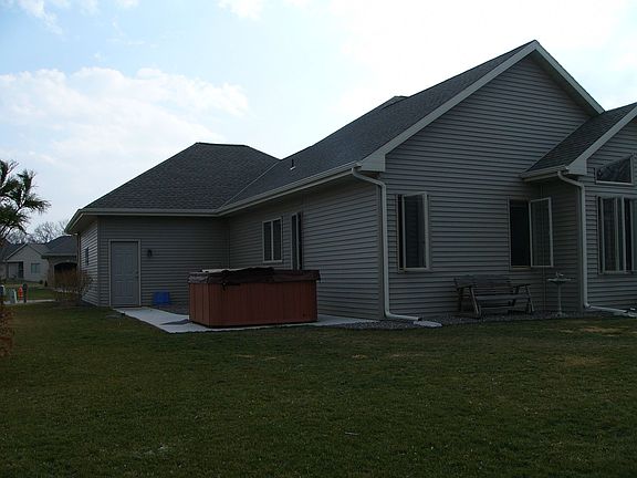 Back of house with Hot Tub