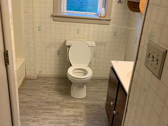 Downstairs bathroom with tub and shower.