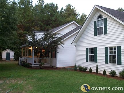 Front of house including pump house