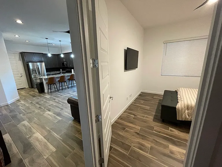 Hall view - Bedroom on right, Living Room and Kitchen on left.