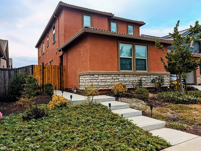 Brand-new solar torches line the steps, providing a warm glow that enhances the curb appeal, especially at night.