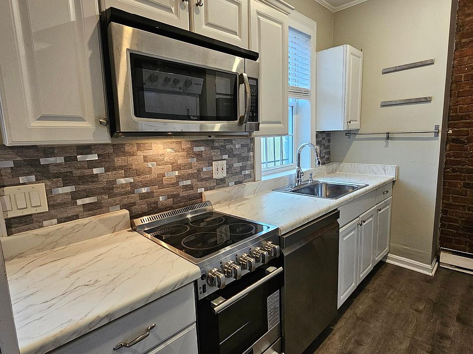 Renovated kitchen with modern, new stainless appliances (stove, d/w, microwave, fridge)
