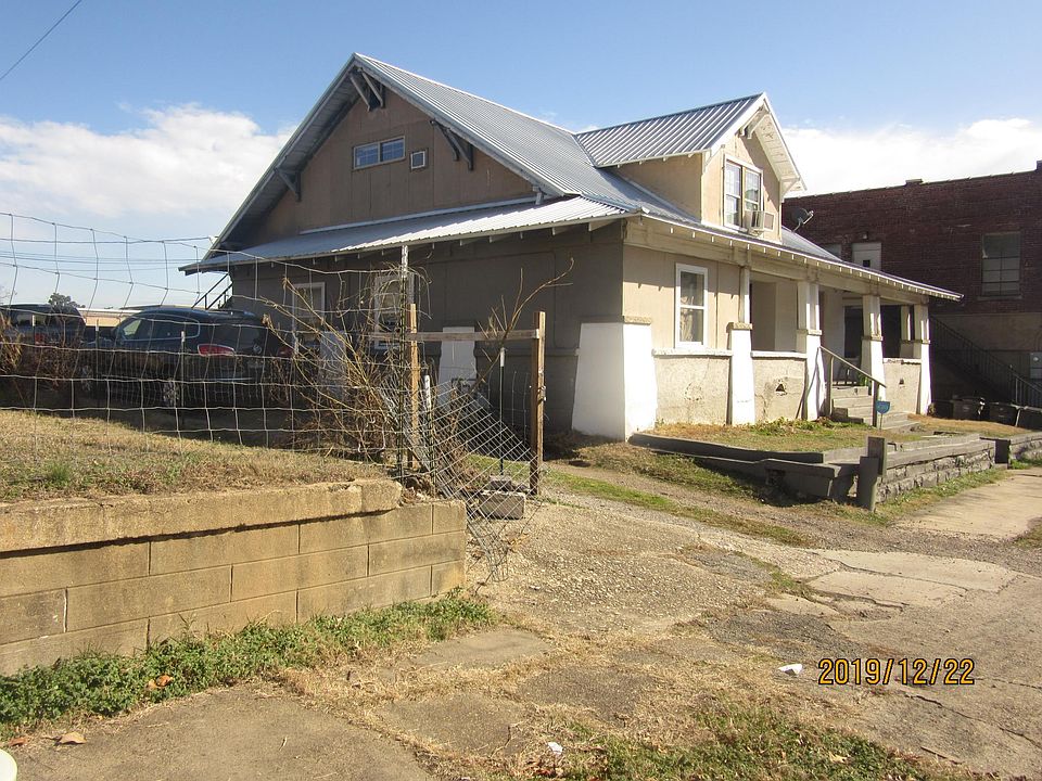 310 HAWTHORNE WITH DRIVEWAY BESIDE BUILDING AND METAL ROOF.
