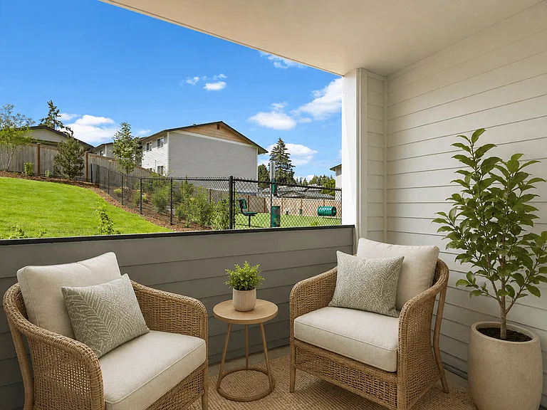 Staged covered apartment patio with outdoor seating, decorative accents, landscaped views, and nearby community dog park. Staged covered apartment patio with outdoor seating, decorative accents, landscaped views, and nearby community dog park.