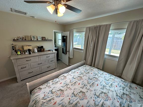 Spacious master bedroom with lots of natural sunlight, faces the pool and backyard area