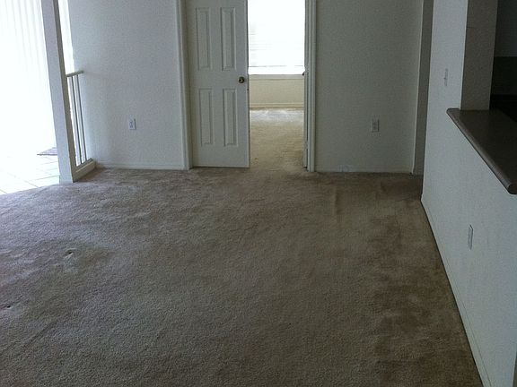 living room and double doors to first bedroom