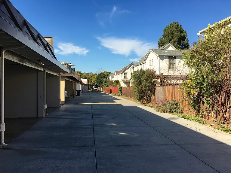 Driveway at rear of building. One carport spot included.