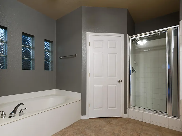 Master bath has separate tub and shower and dual closets.