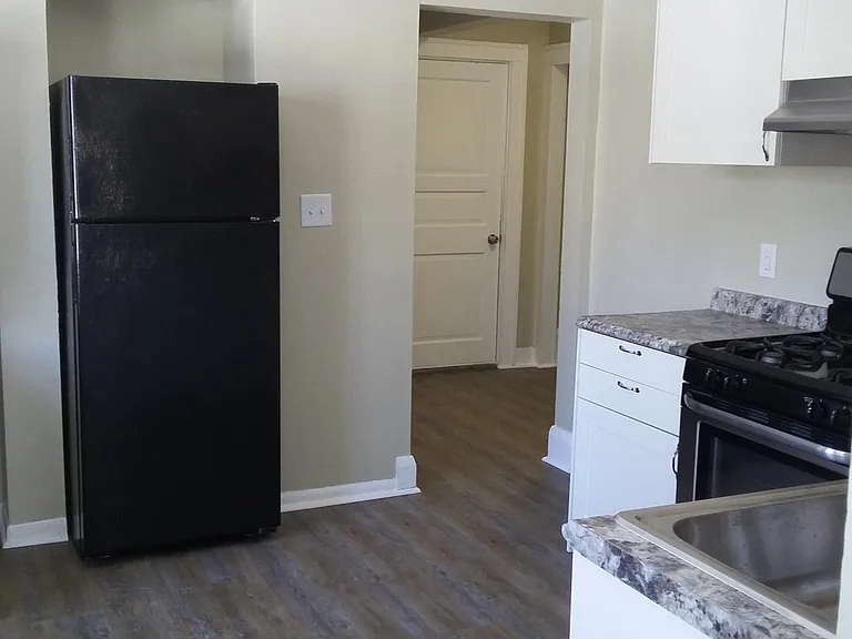 Kitchen view from LR showing access to second floor loft area. Yes, two floors!